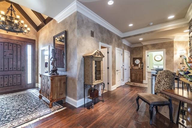 entrance foyer with a chandelier, ornamental molding, baseboards, and dark wood-style flooring