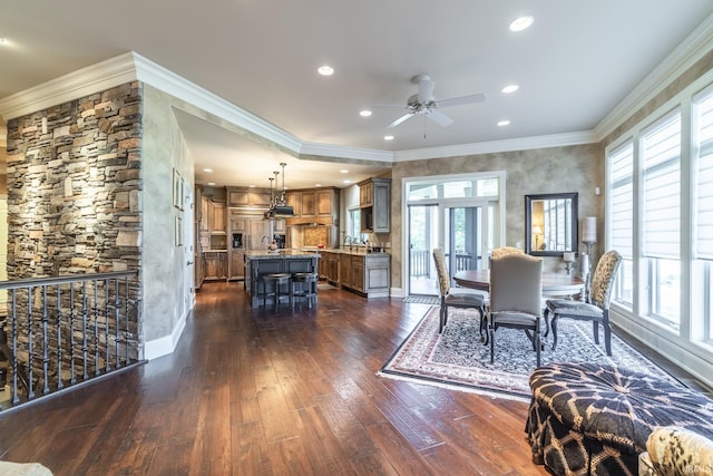dining room with baseboards, recessed lighting, ceiling fan, ornamental molding, and dark wood-type flooring