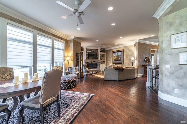 dining space with wood finished floors, a ceiling fan, a fireplace, recessed lighting, and ornamental molding