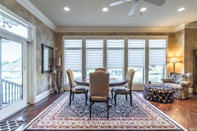 dining room with baseboards, dark wood-type flooring, ceiling fan, and crown molding