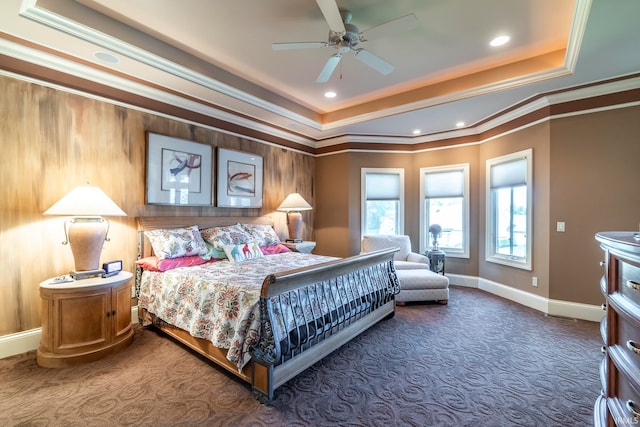 carpeted bedroom featuring ceiling fan, a raised ceiling, and ornamental molding