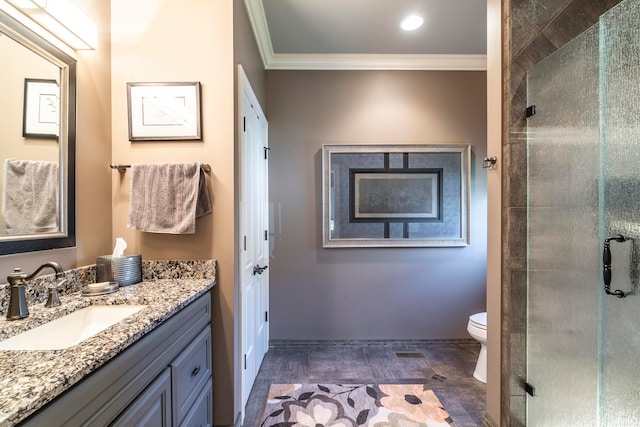 bathroom with ornamental molding, vanity, toilet, and a shower with shower door