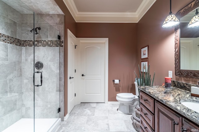 bathroom featuring vanity, crown molding, toilet, and a shower with door