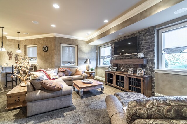 carpeted living room with ornamental molding and a fireplace