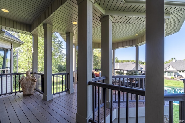 wooden terrace with a residential view and covered porch
