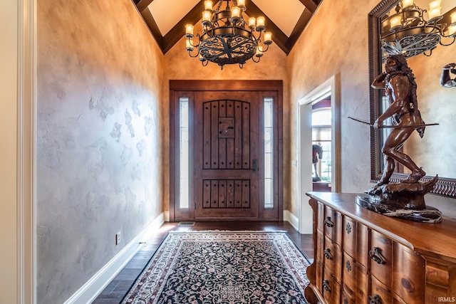 foyer featuring beamed ceiling, dark wood-type flooring, a chandelier, and high vaulted ceiling