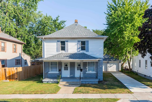 front of property featuring a front yard, a porch, and a garage