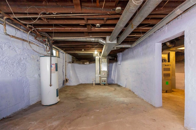 basement featuring water heater and heating unit