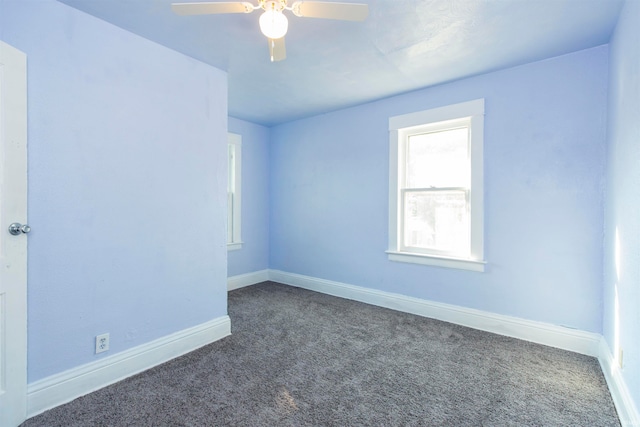 carpeted spare room featuring ceiling fan