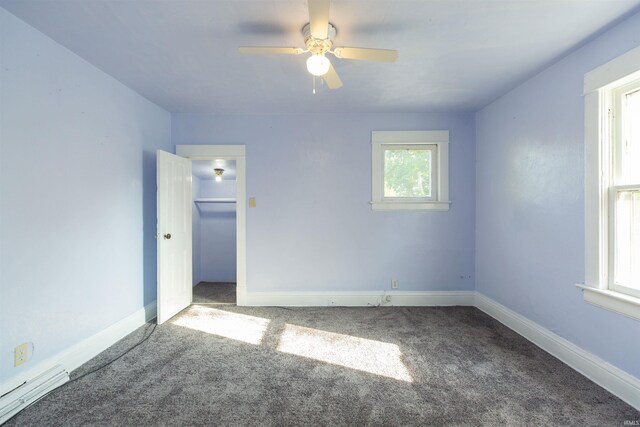 unfurnished bedroom with carpet, multiple windows, and ceiling fan