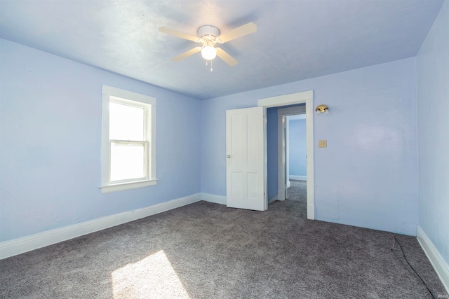 unfurnished bedroom featuring dark carpet and ceiling fan