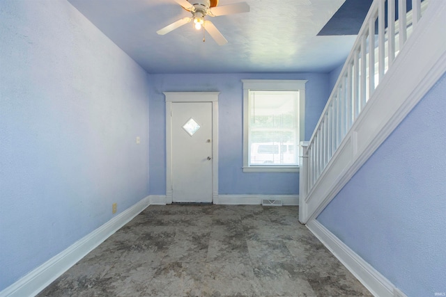 foyer entrance with ceiling fan