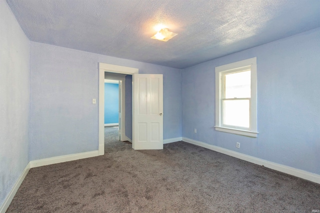 unfurnished bedroom featuring a textured ceiling and carpet flooring