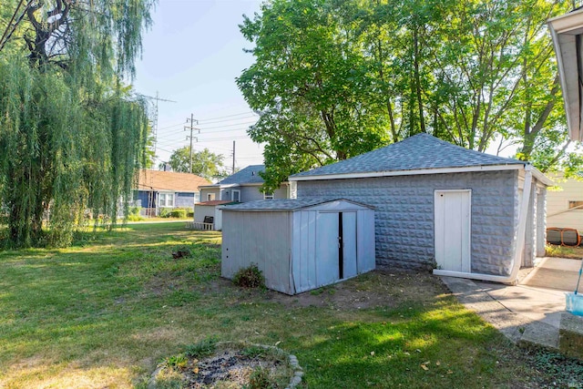 view of outbuilding featuring a lawn