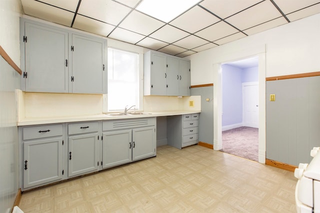 kitchen with light parquet floors, sink, and gray cabinets