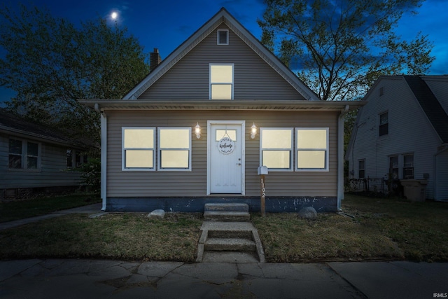 bungalow featuring a yard