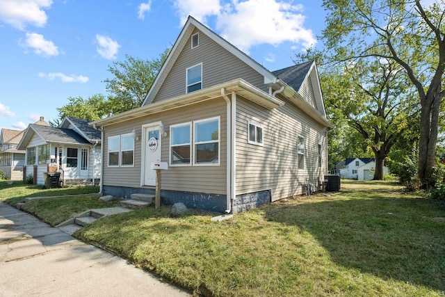 view of side of home with a lawn and cooling unit