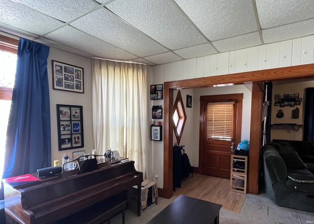 miscellaneous room with light wood-type flooring and a drop ceiling