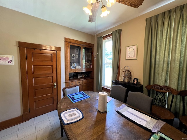 tiled dining room with ceiling fan