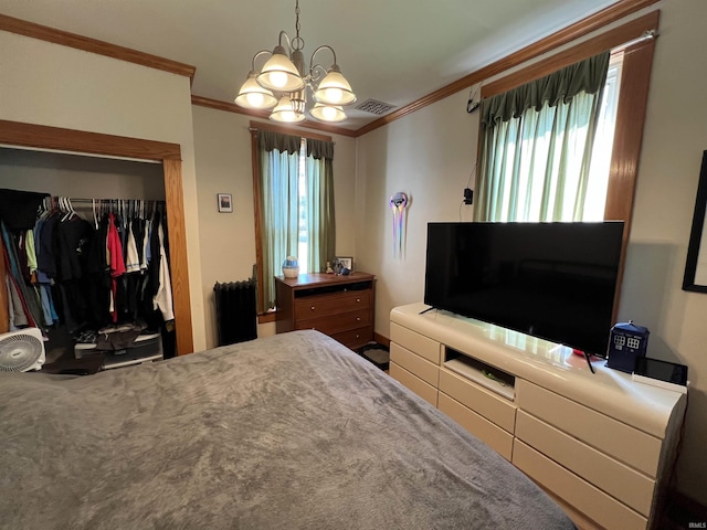 carpeted bedroom featuring a closet, a chandelier, and ornamental molding