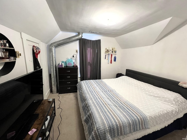 carpeted bedroom with lofted ceiling