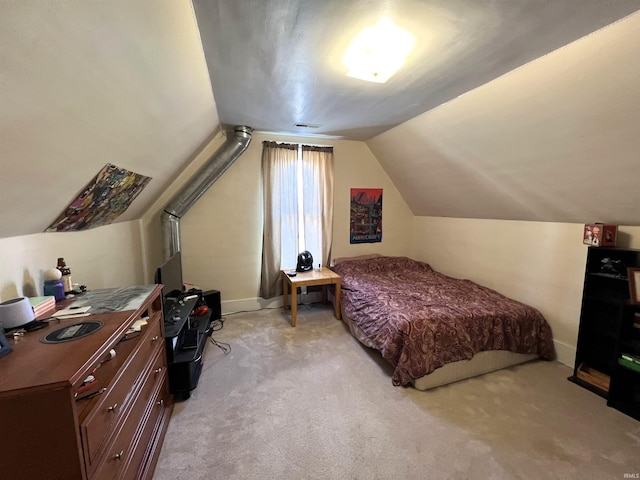 bedroom featuring light colored carpet and vaulted ceiling