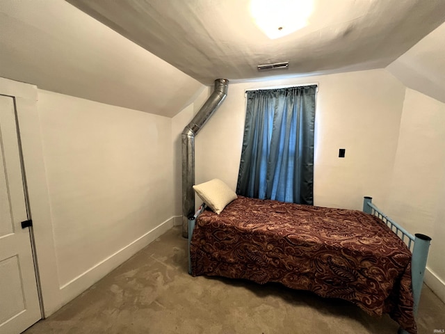 bedroom with lofted ceiling and light carpet