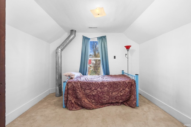 carpeted bedroom with vaulted ceiling