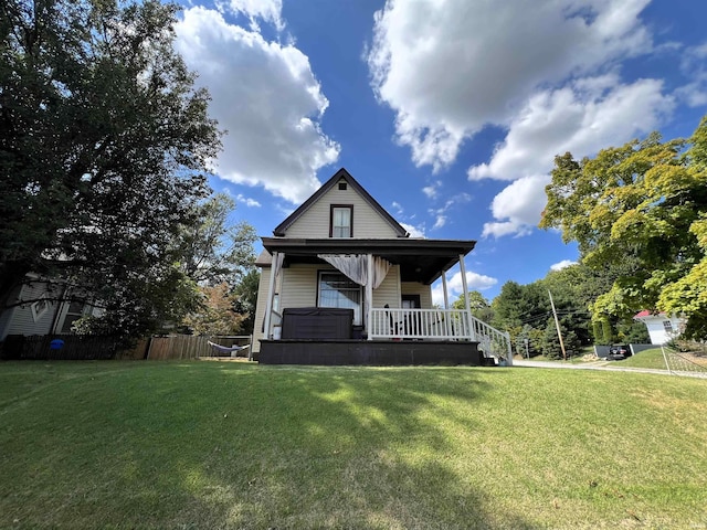 view of front of property featuring covered porch and a front lawn