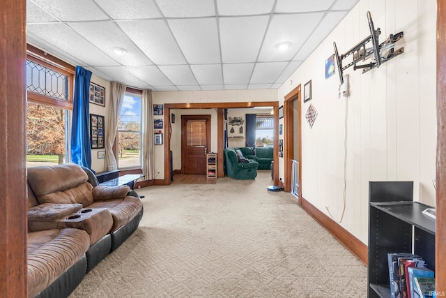 living room with carpet floors and a drop ceiling