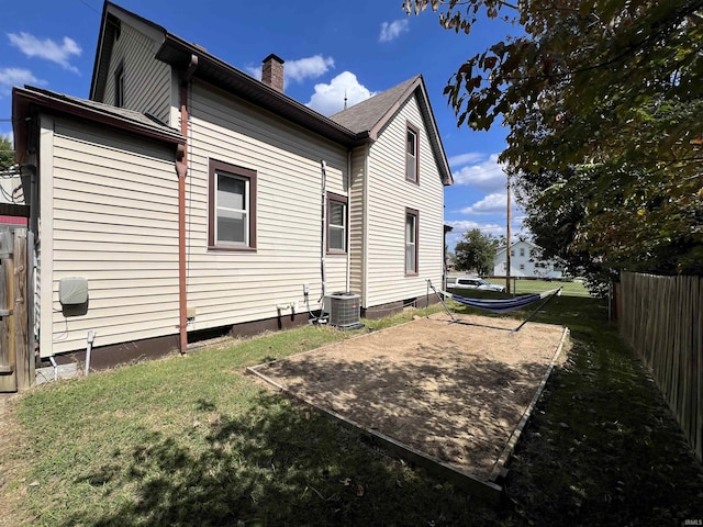 view of side of home featuring a yard