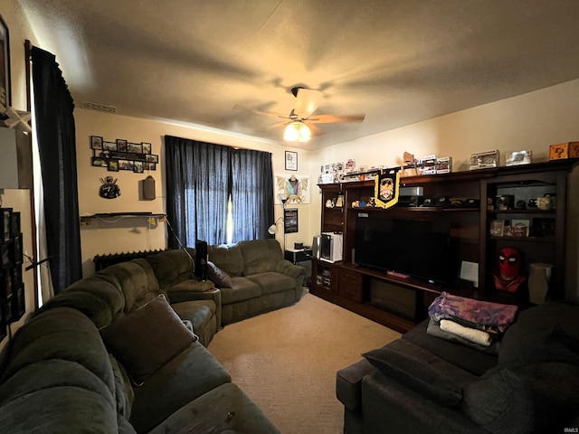 carpeted living room with ceiling fan