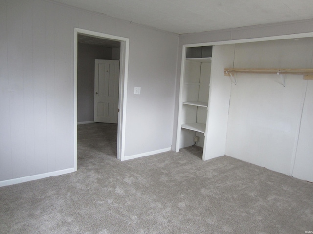 unfurnished bedroom with light carpet and a closet