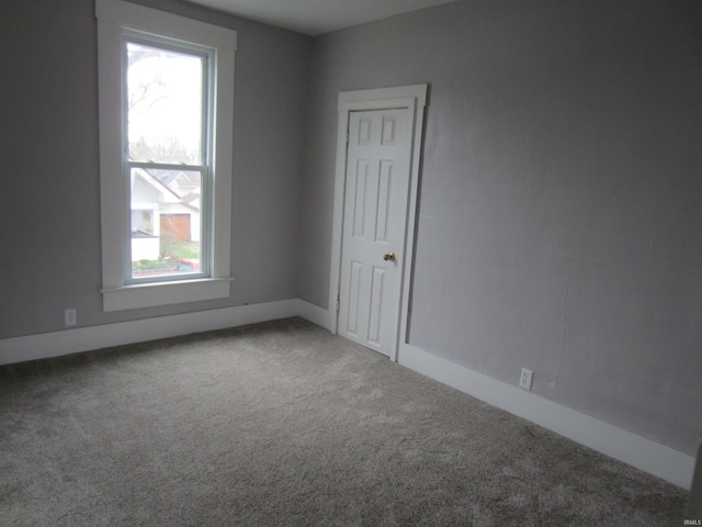 carpeted empty room with a wealth of natural light