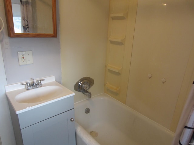 bathroom with bathing tub / shower combination and vanity