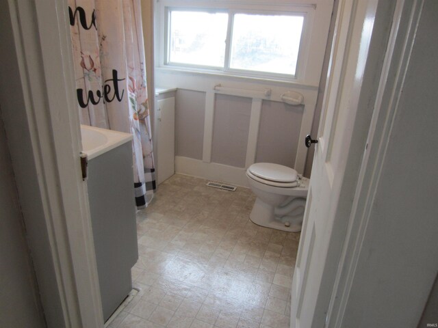 bathroom featuring vanity, toilet, and a shower with shower curtain