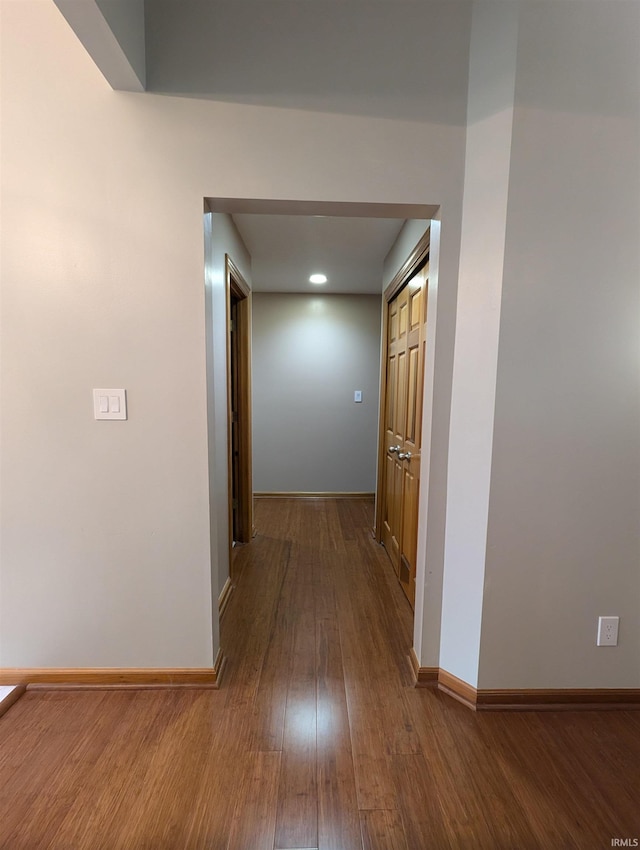 hall with hardwood / wood-style flooring