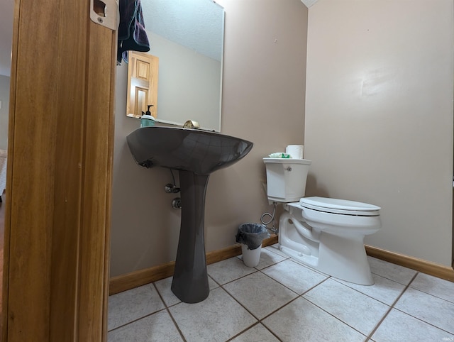 bathroom featuring tile patterned flooring and toilet