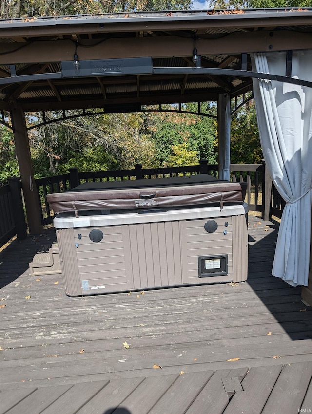 wooden deck featuring a gazebo and a hot tub