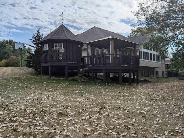 back of property with a gazebo and a deck