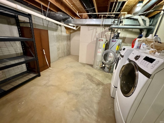 basement with water heater and washer and clothes dryer