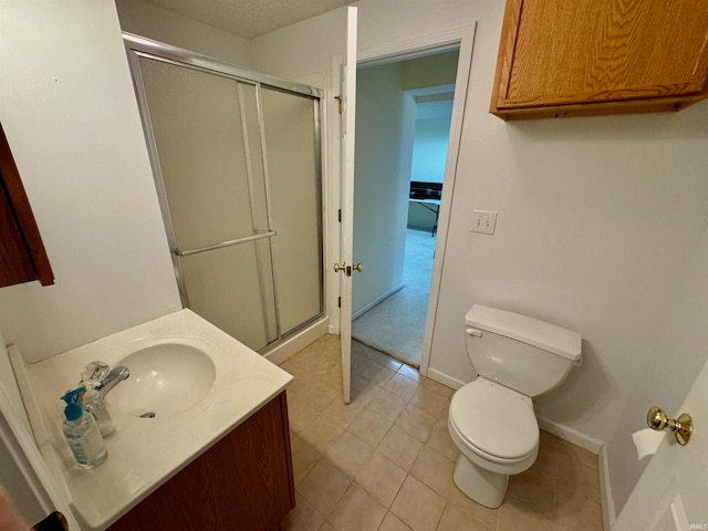 bathroom with tile patterned flooring, vanity, toilet, and a shower with shower door