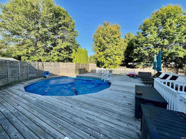 view of swimming pool featuring a wooden deck