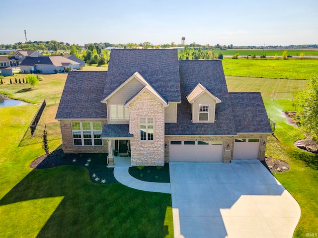 view of front of home featuring a front yard and a garage