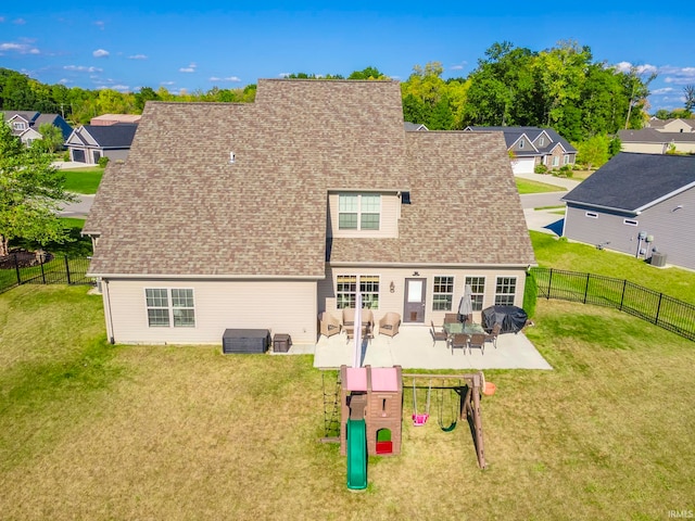 back of property featuring a lawn and a patio area