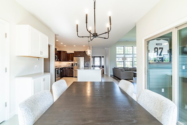 dining space featuring sink and a chandelier