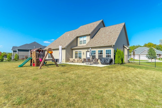 rear view of house with a playground, a yard, and a patio area