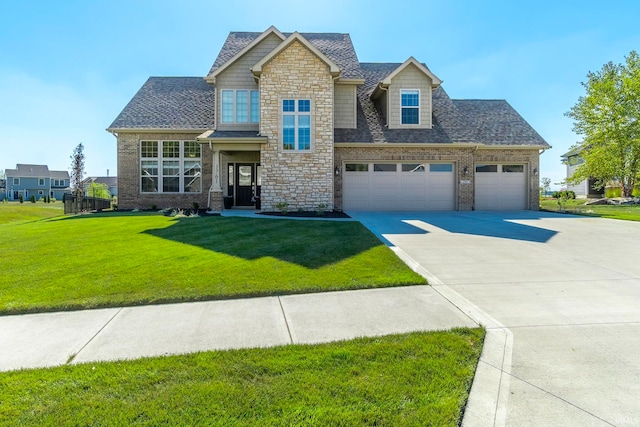 view of front of house with a garage and a front lawn