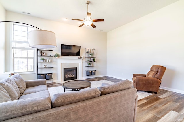 living room featuring ceiling fan and light hardwood / wood-style flooring