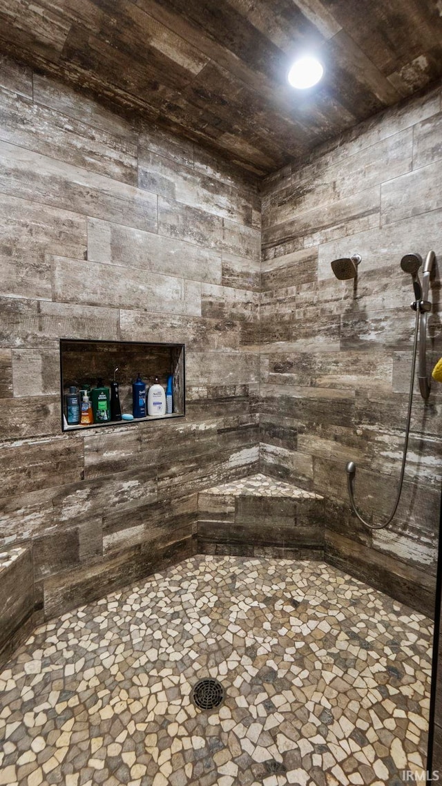 bathroom with a shower and wooden ceiling